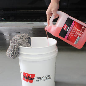 Malco CW-37 gallon beside everyday objects showing scale and economical volume