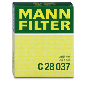 Mann Filter held during roadside replacement showing quick maintenance benefit