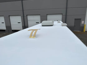 Marlin Coatings being rolled onto an RV roof demonstrating easy one-coat application
