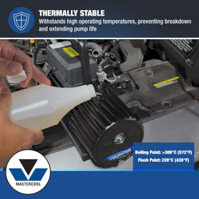 Mastercool oil being poured into a vacuum pump for clean, efficient service
