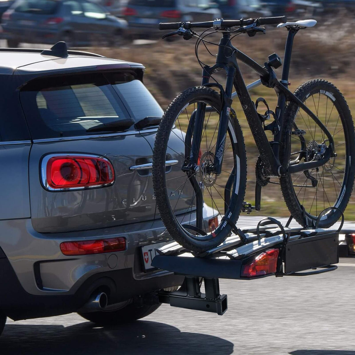 MAXXHAUL installed on vehicle with bike rack showing real-world towing versatility