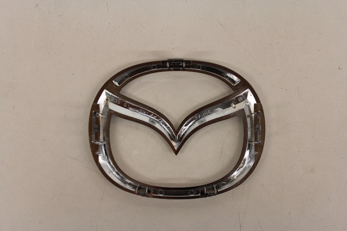 Mazda emblem close-up chrome detail highlighting high-quality finish and durability