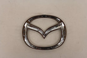 Mazda emblem close-up chrome detail highlighting high-quality finish and durability
