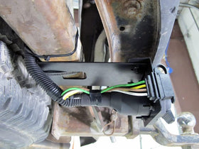 MECMO adapter connected to trailer in outdoor setting enabling quick hookup on the road