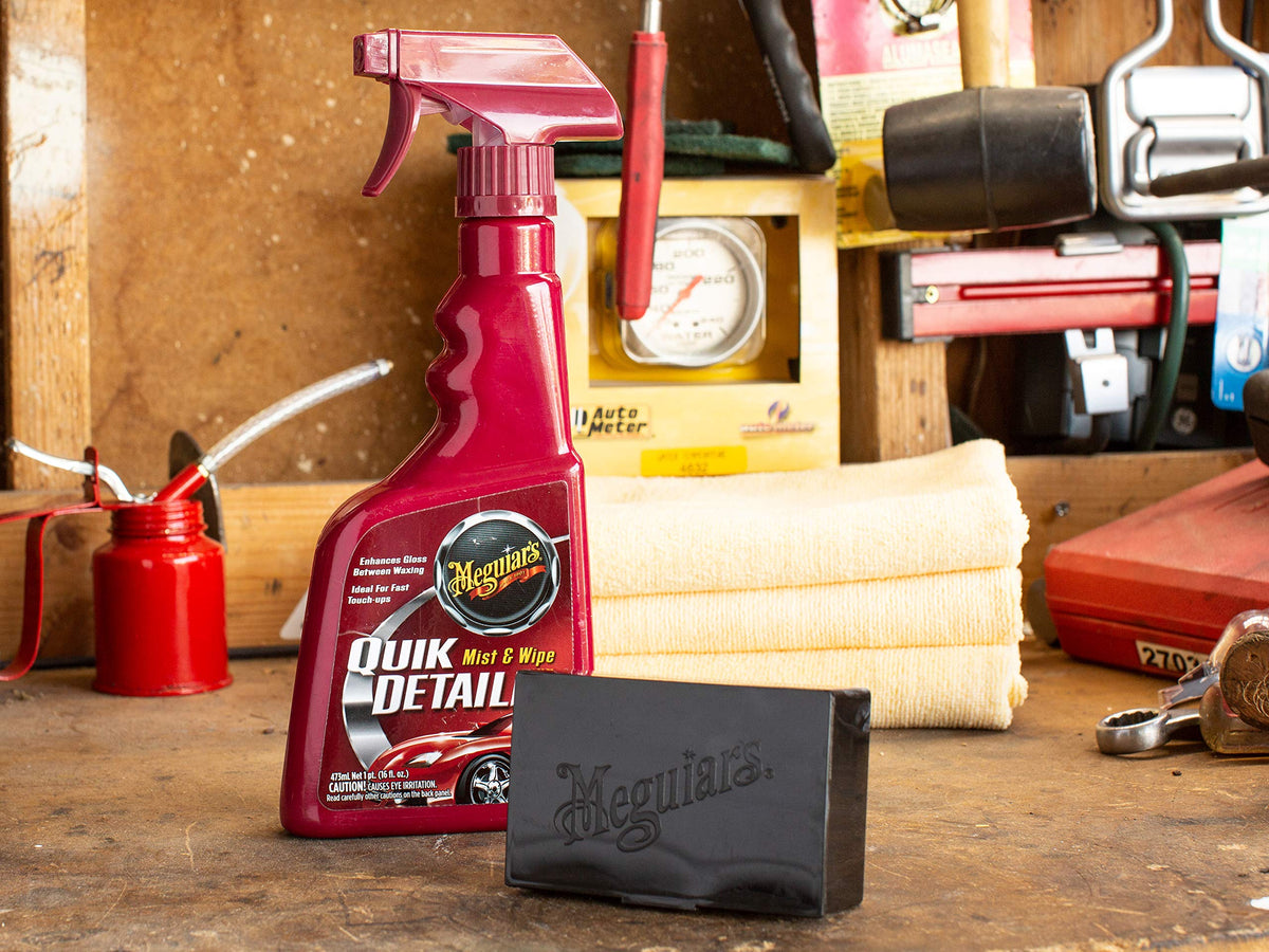 Meguiar's clay bar in use on a door panel for contaminant removal