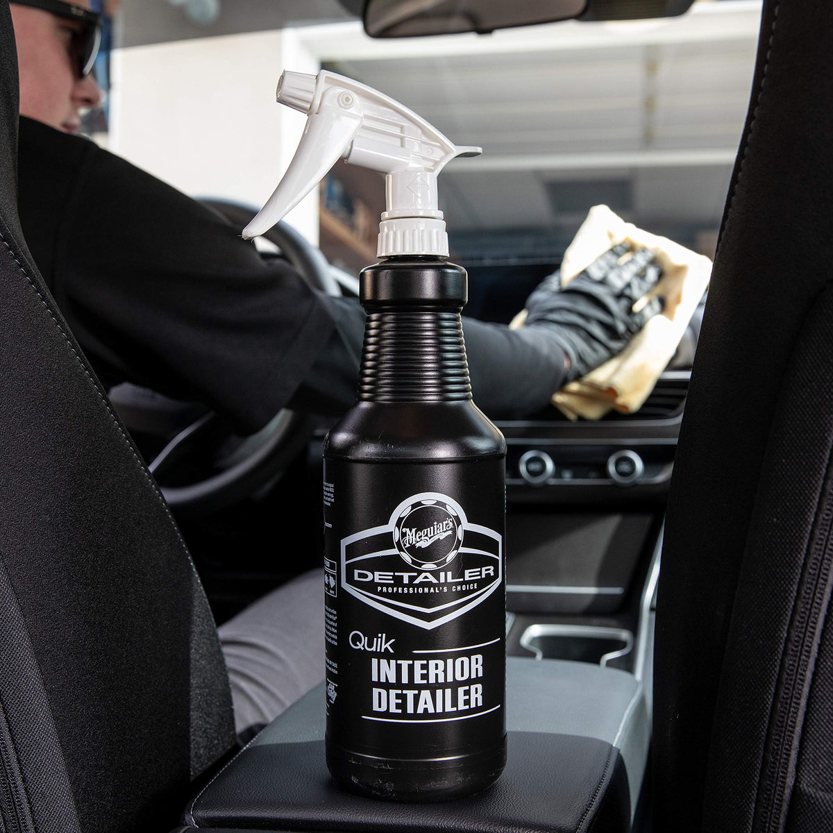 Meguiar's product being wiped on dashboard showing safe quick cleaning benefit