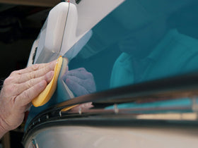 Meguiar's M5016 being applied to a boat gel coat demonstrating restored color and glossy finish
