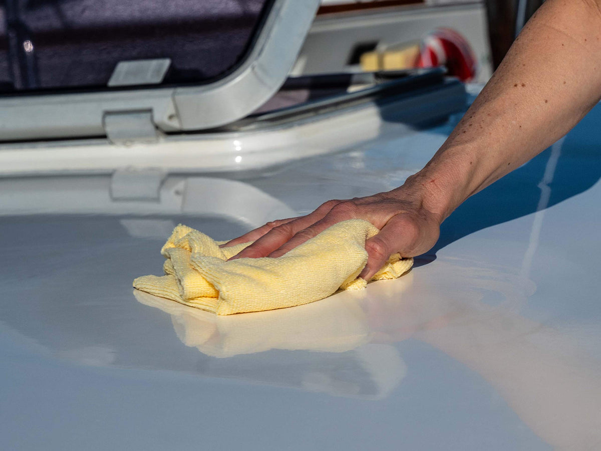 Meguiar's M9132 before and after on boat bow showing restored glossy gel coat
