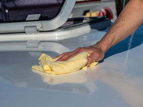 Meguiar's M9132 before and after on boat bow showing restored glossy gel coat