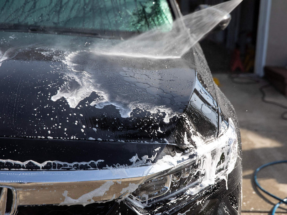 Meguiar's gallon beside a sponge and car for scale, useful for judging quantity and value
