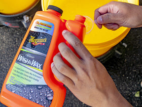 Meguiar's bottles in hand for size comparison showing convenient at-home maintenance