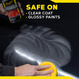 Meguiar's compound next to a hand for size and usage scale