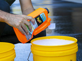 Meguiar's wash mitt and bucket setup demonstrating safer two-bucket washing technique