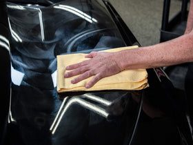 Meguiar's finished car surface in driveway showcasing deep gloss and color enhancement