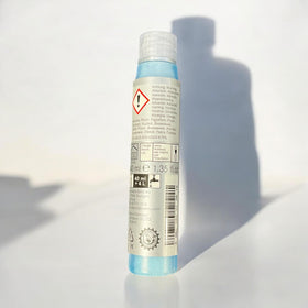 Mercedes‑Benz Summerfit concentrate being poured into a washer reservoir showing quick, measured mixing benefit