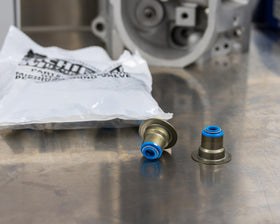 Michigan Motorsports seal beside coin for scale to show precise dimensions