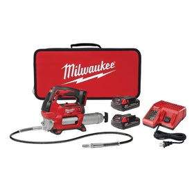 Milwaukee grease gun held in hand to show compact scale and easy maneuverability for tight spaces