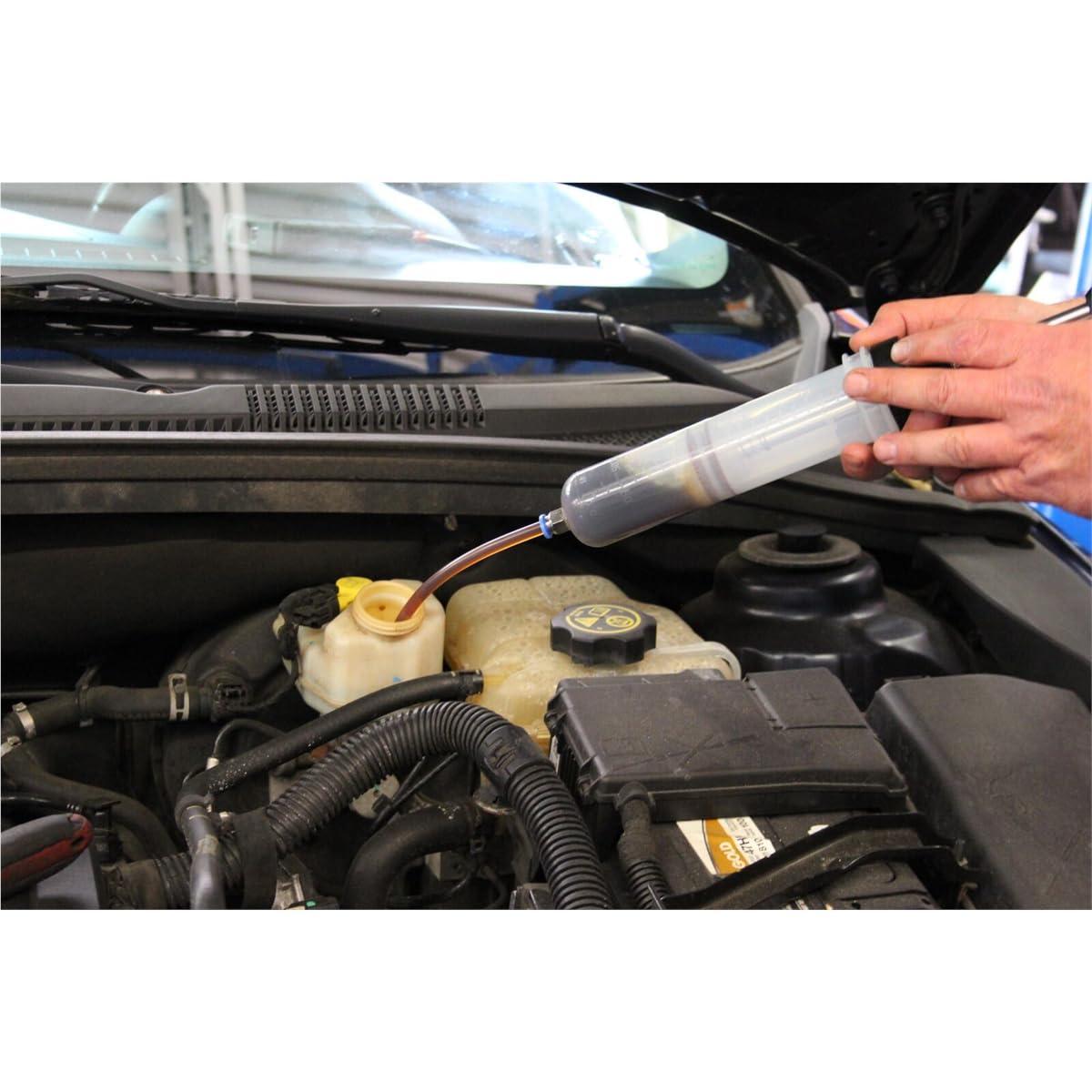Mityvac extracting brake fluid from a master cylinder for precise bleeding