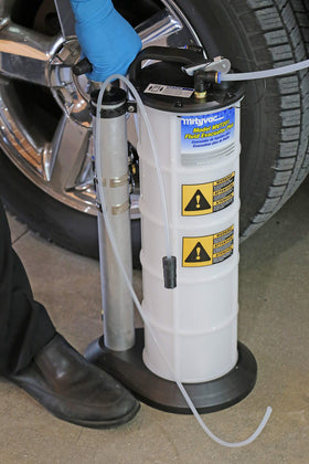 Mityvac next to a ruler for scale showing portable 2.3 gallon capacity benefit