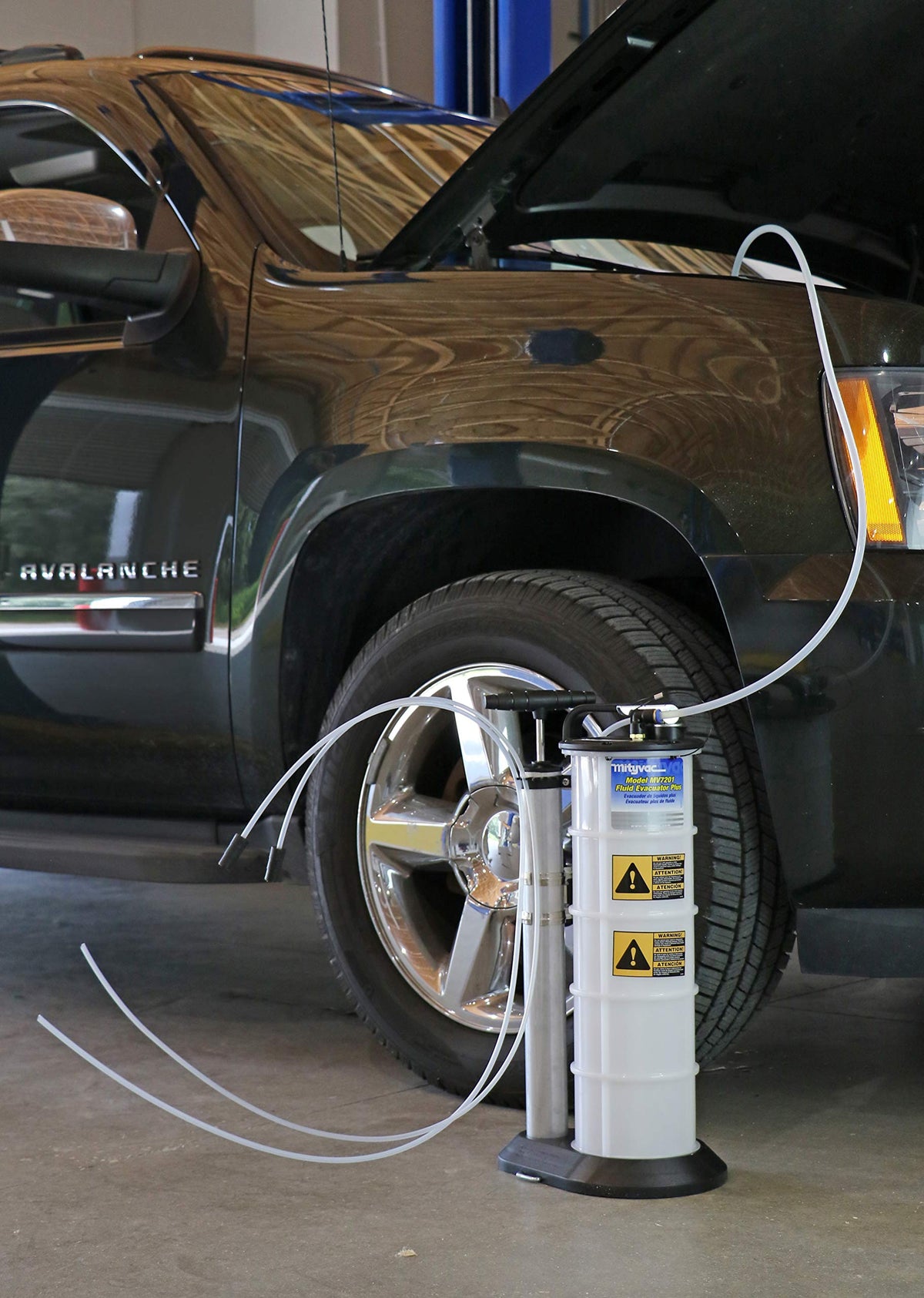 Mityvac in a workshop setting with tools showing professional-ready portability benefit