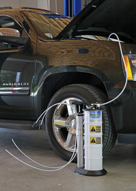 Mityvac in a workshop setting with tools showing professional-ready portability benefit