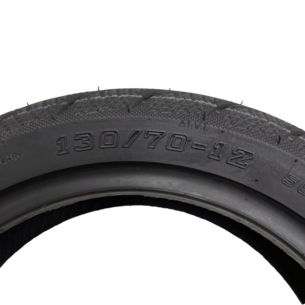 MMG rear 130/70-12 tire tread closeup highlighting block pattern grip