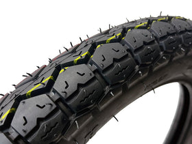 MMG front tire tread close-up showing compound and grooves for wet grip