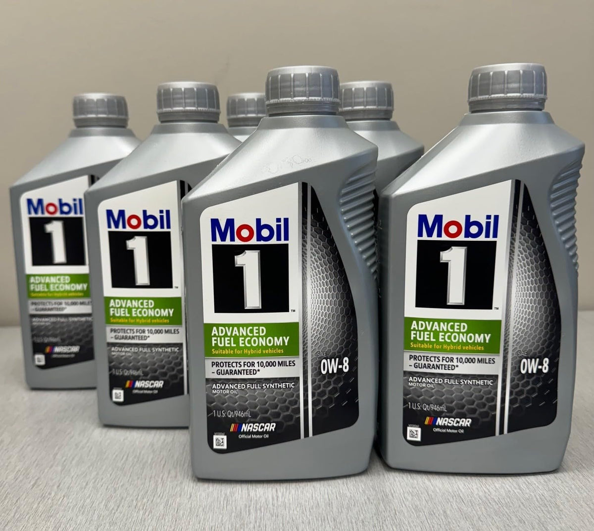 Mobil 1 being poured into an engine bay showing fast cold-start protection