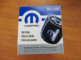 Mopar oil filter being installed in a Ram 6.4L Hemi for proper maintenance