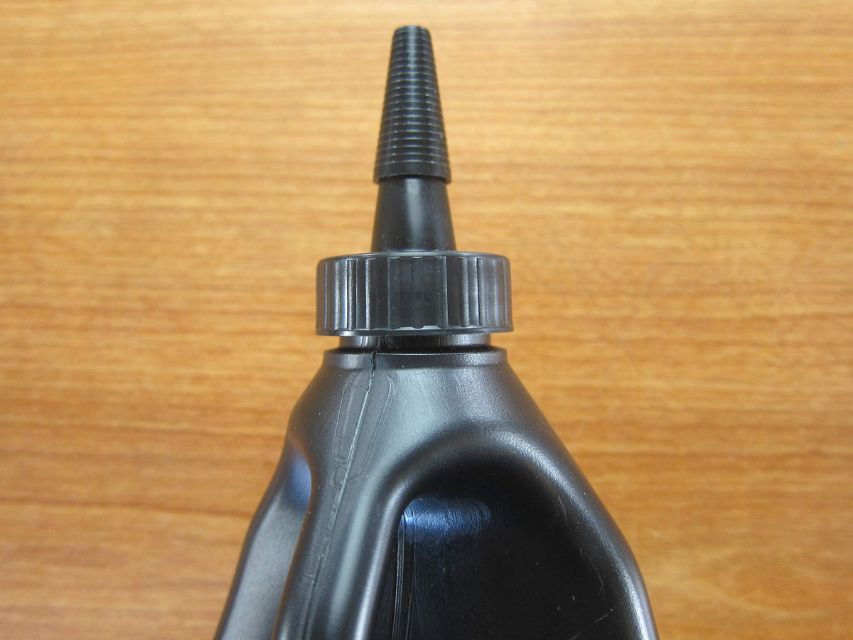 Mechanic in garage using Mopar oil for axle service promoting OEM compatibility and confidence