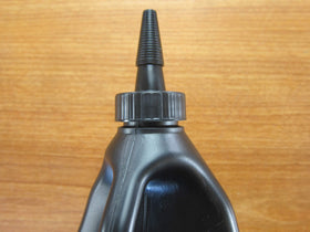 Mechanic in garage using Mopar oil for axle service promoting OEM compatibility and confidence