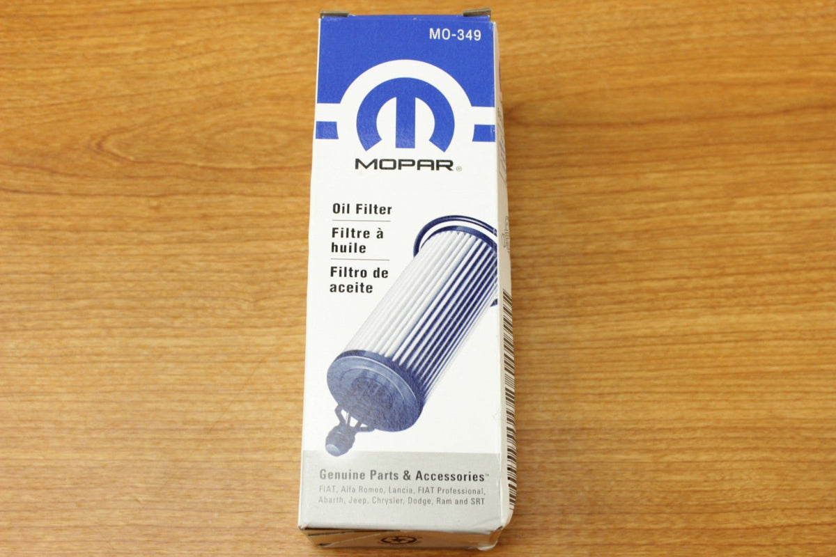 Mopar oil filter held in hand to show size and easy DIY handling benefit