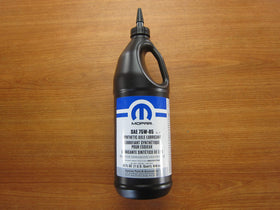 Mopar bottle pouring gear oil into differential with clean funnel for precise, mess-free service