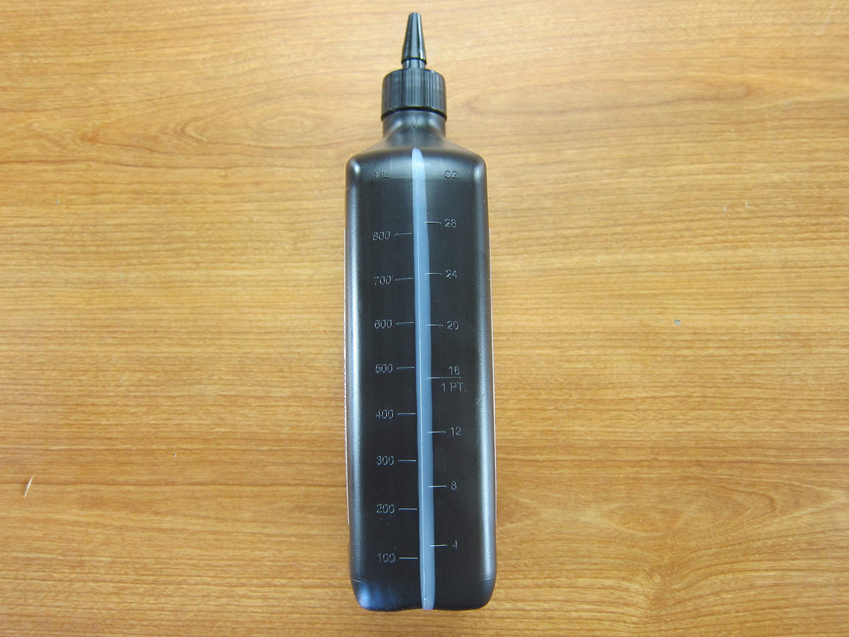 Mopar two-quart bottle next to vehicle part for scale and fit confirmation