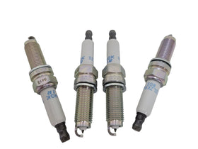 MOROTUS spark plug next to coin size comparison showing scale benefit