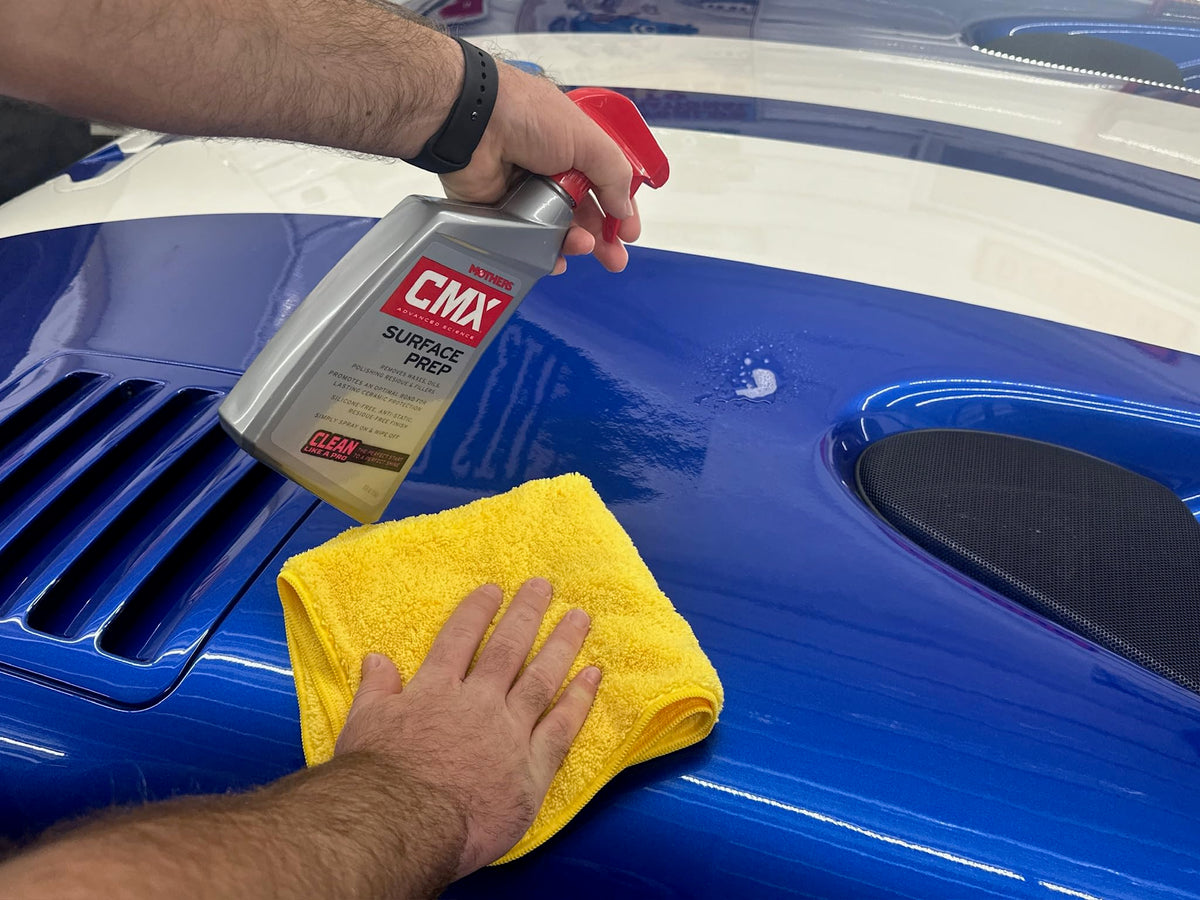 Mothers CMX being sprayed on car paint demonstrating easy application for better adhesion