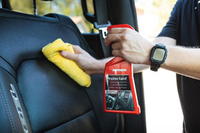 Mothers Protectant gallon held to show real size and scale