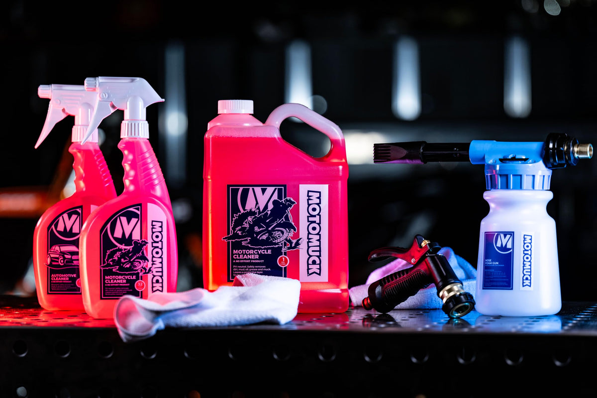 Motomuck cleaner being sprayed on a motorcycle fairing illustrating safe, effective dirt removal