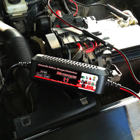 MOTOPOWER beside a hand to show compact size and storage convenience