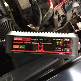 MOTOPOWER MP00207A with a hand for scale showing the compact size and portability