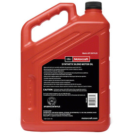 Motorcraft oil bottle beside engine during oil change, highlighting professional-grade protection