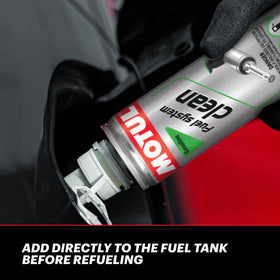 Motul fuel system clean being poured into fuel tank for easy maintenance