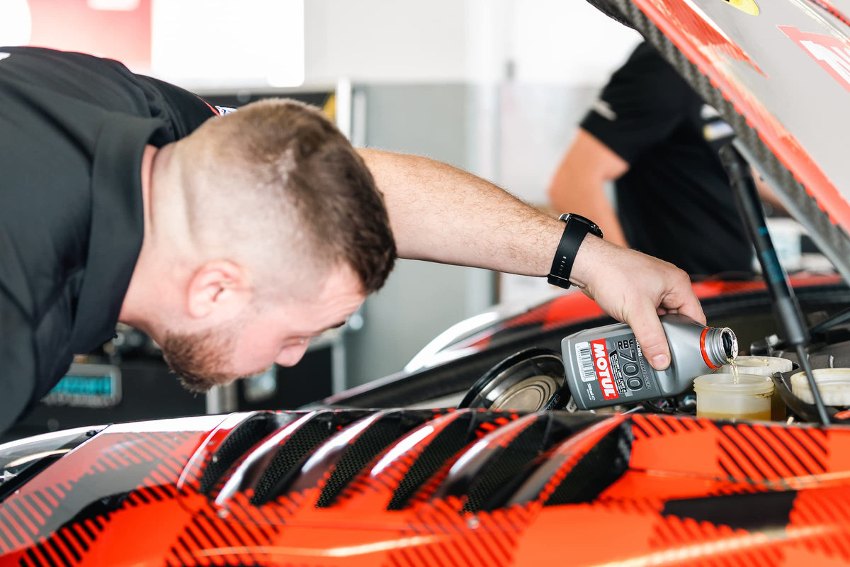 Motul RBF 700 in a workshop with tools, illustrating professional servicing advantage