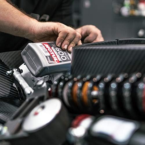 Motul RBF 600 bottle beside a track car, highlights race-ready braking performance