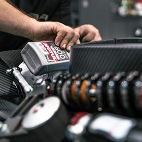 Motul RBF 600 bottle beside a track car, highlights race-ready braking performance