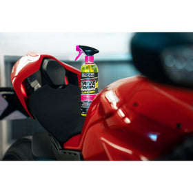 Muc-Off spraying on motorcycle drivetrain for fast degreasing