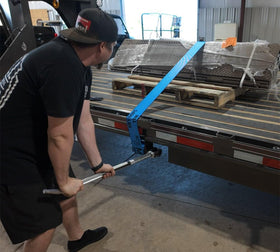 Mytee Products winch bar in use on flatbed trailer demonstrating safer strap tensioning