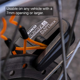 NEIKO lock attached to motorcycle in urban parking providing audible theft deterrence