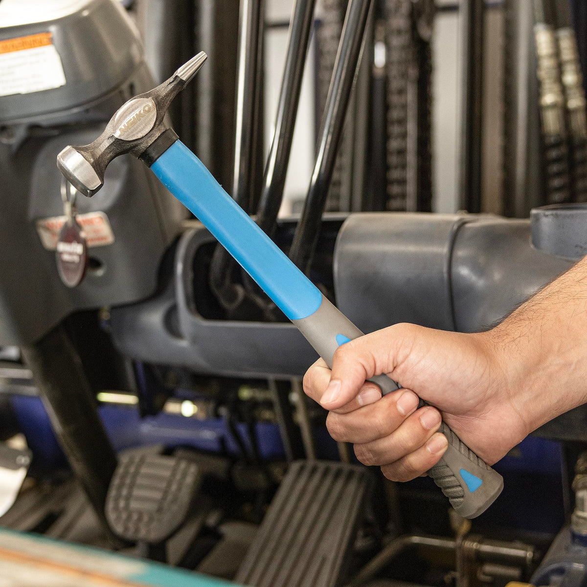 NEIKO hammer and dolly in use on car fender demonstrating controlled dent repair benefit