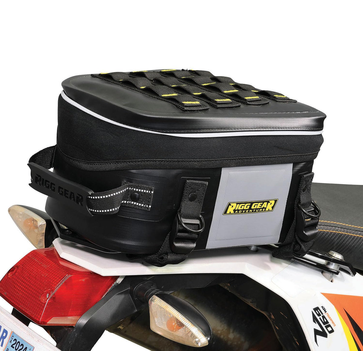 Nelson-Rigg beside helmet for scale showing compact 12L capacity benefit